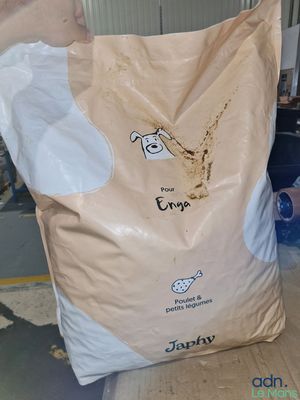 a bag of rice sitting on the floor in a warehouse