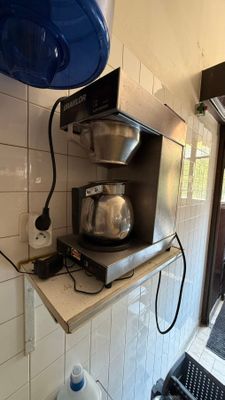 a coffee maker sitting on a counter in a kitchen