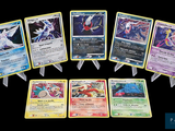 a lot of pokemon cards that are on a table