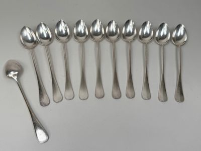 six spoons and two spoons sitting on a table