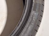 a close up of a tire on a white surface with a black rim