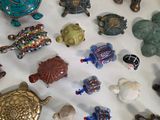 many different kinds of figurines displayed on a table