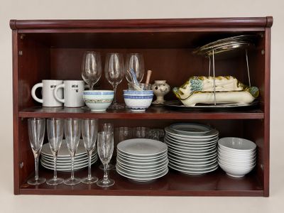 a wooden shelf with dishes and glasses on it