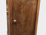 a small wooden cabinet with a drawer on top of it