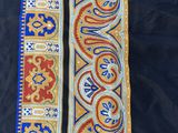 a close up of a blue and orange scarf with a design on it