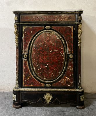 a red and black cabinet with gold decorations on it