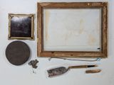 a picture of a picture frame, a knife, and other items on a table
