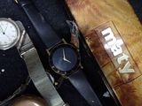 two watches sitting next to each other on a table