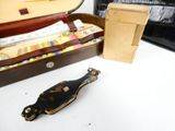 a brown case with a black handle sitting on a white table