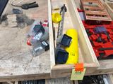 a wooden box filled with assorted tools on a workbench