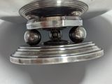 a silver plate with a ball on top of it
