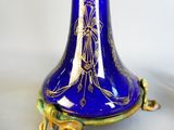 a blue vase with a gold decoration on it