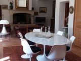 a table and chairs in a living room with a chandelier
