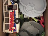 a cardboard box filled with assorted toys and other items