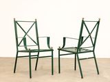 pair of green metal chairs in the style of a pair of folding chairs