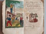 an old book with a picture of a man on a ladder