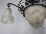 a light that is hanging from the side of a light fixture