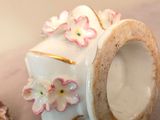 a small vase with flowers on it sitting on a table