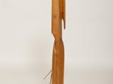 a wooden sculpture of a person with a long neck