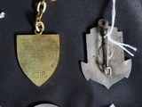 four different types of metal items on a black surface