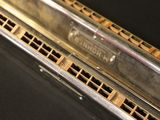 a close up of a harmonica on a black surface