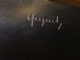a close up of a black vase with writing on it