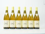 six bouteilles de vin sont alignées sur une table