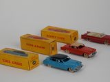 several toy cars are lined up next to each other on a white surface