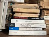 many books stacked on top of each other on a table