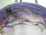 a glass bowl hanging from a chain on a wall