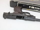 a gun that is sitting on a table next to a book