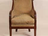 a chair with a striped upholstered back and arms