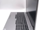 a silver laptop computer sitting on top of a white table