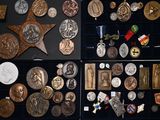 a lot of medals and medals on display in a case