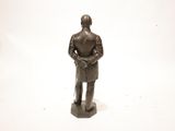 a statue of a man with a hat and a cane