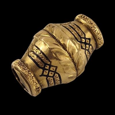 a gold vase on a black background with a black background