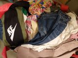 a suitcase full of clothes and a hat on the floor