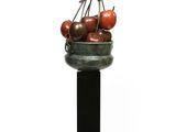 an image of a sculpture of a basket of tomatoes on a pedestal