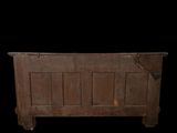 an old wooden chest on display against a black background