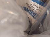 a person holding a bottle of water in a plastic bag