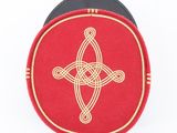 a red box with a gold celtic design on it