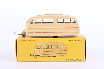 toy bus sitting on top of a cardboard box on a white surface