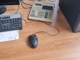 a computer desk with a keyboard, mouse and monitor on it