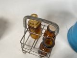 a small metal rack with bottles of honey on it