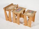 three wooden tables that are sitting next to each other