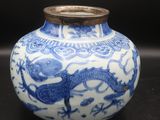 a blue and white vase with a dragon on it