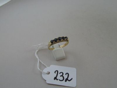 a white tag with a black stone ring on it