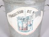 a large metal bucket with a sign on it