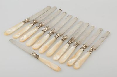 a set of eight ivory handled knives with silver handles