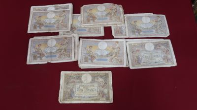 several different types of money laid out on a red table